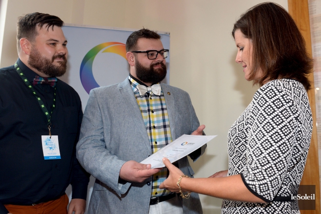 The President of Alliance Arc-en-ciel de Qu�bec Mr. J�r�me Bergeron, accompanied by the Director General Mr. Louis-Filip Tremblay, personally giving the organization's Memorandum on the Struggle Against Homophobia and Transphobia  to the Minister of Justice, Ms. St�phanie Vall�e.